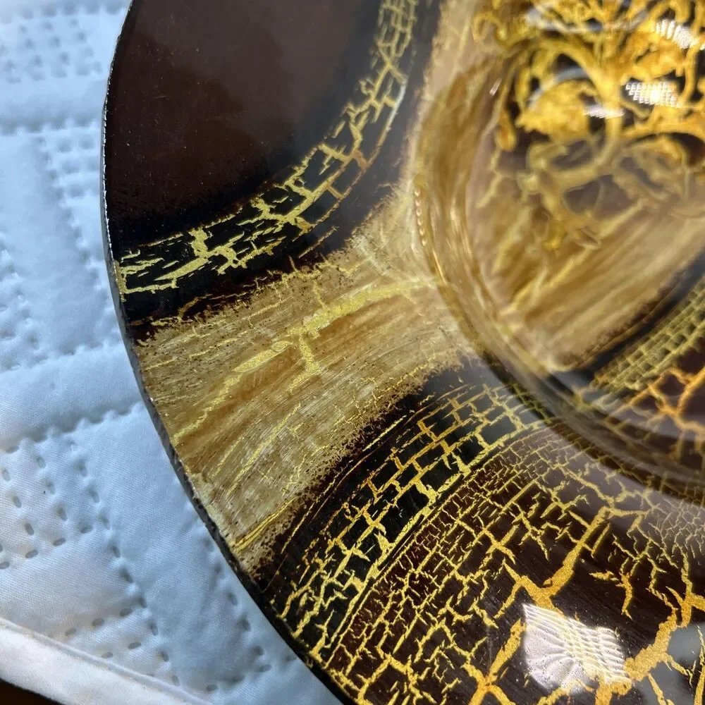Glass bowl features an asymmetrical shape with a striking black and gold crackle